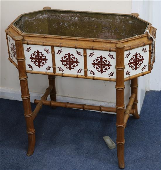 A Victorian tile inset faux bamboo planter with brass liner W.77cm